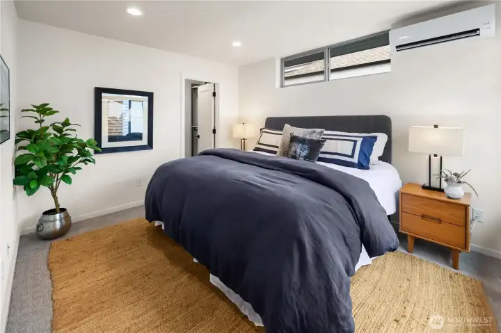 Generously sized primary bedroom. This is a king size bed. Through the open door in the middle of this photo is the custom walk in closet.