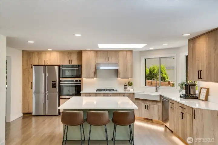 Light from the skylight brightens the living area throughout the day, while toe-kick lighting adds a subtle finishing touch in the evening. Light from the skylight brightens the living area throughout the day, while toe-kick lighting adds a subtle finishing touch in the evening.