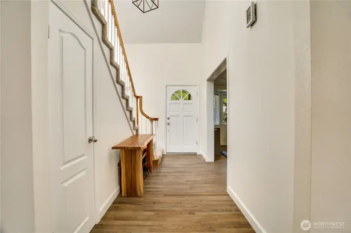 As we move from the family room and kitchen into the main-floor hallway, take a moment to notice the coat closet with extended under-stair storage. Now, let's head upstairs. As we move from the family room and kitchen into the main-floor hallway, take a moment to notice the coat closet with extended under-stair storage. Now, let's head upstairs.