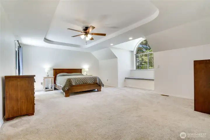 The primary suite features a built-in window seat, cove ceiling detail, and newly installed blinds. The primary suite features a built-in window seat, cove ceiling detail, and newly installed blinds.