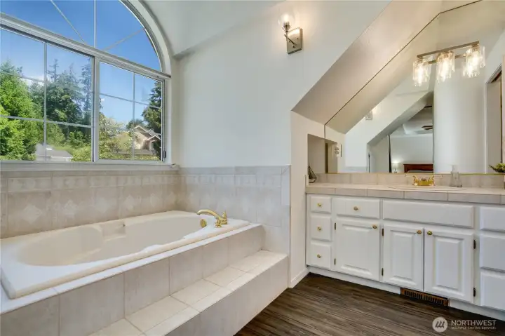 Freshly painted cabinets, updated lighting, and a large soaking tub create a relaxing retreat. A sunny window—with brand-new blinds just installed—fills the space with natural light. Freshly painted cabinets, updated lighting, and a large soaking tub create a relaxing retreat. A sunny window—with brand-new blinds just installed—fills the space with natural light.