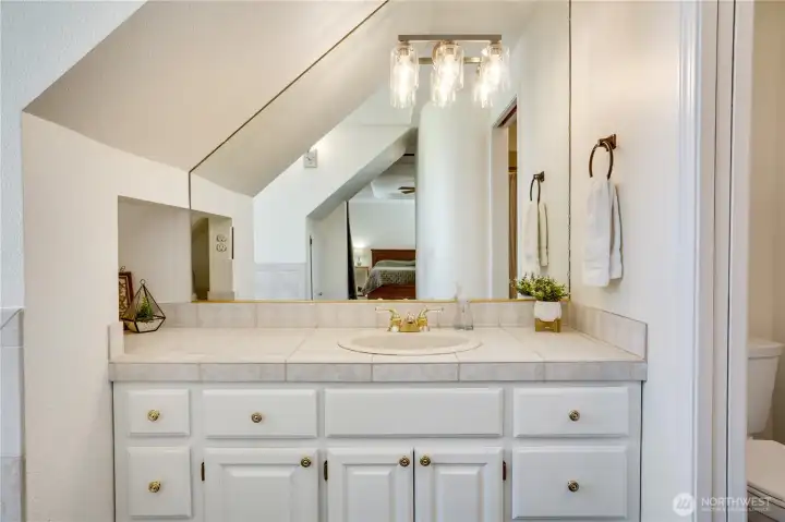 Enjoy abundant storage, generous counter space, a large mirror for getting ready, and updated lighting that completes the space. Enjoy abundant storage, generous counter space, a large mirror for getting ready, and updated lighting that completes the space.