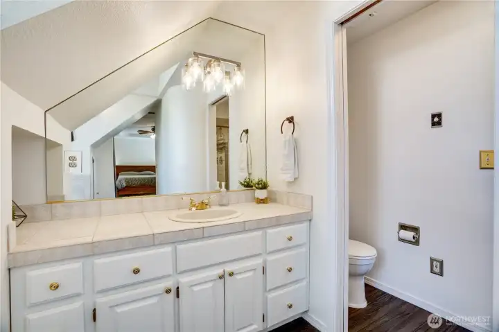 This bathroom features a walk-in shower with tile surround, thoughtfully separated from the vanity area for ease and functionality. This bathroom features a walk-in shower with tile surround, thoughtfully separated from the vanity area for ease and functionality.