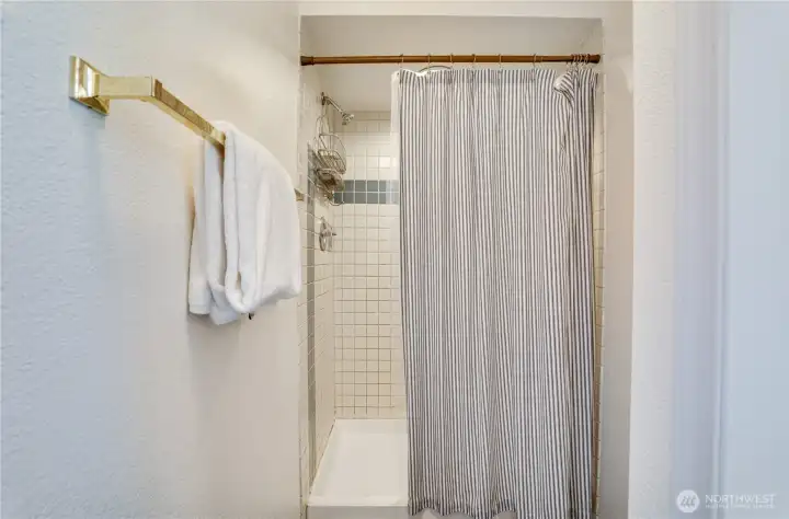 This bathroom features a spacious walk-in shower with tile surround, thoughtfully separated from the vanity area for ease and functionality. This bathroom features a spacious walk-in shower with tile surround, thoughtfully separated from the vanity area for ease and functionality.
