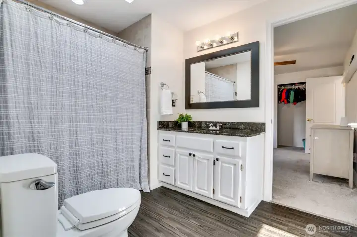 This full bath features LVP flooring, a newly painted vanity with a granite countertop, and a sunny skylight that fills the space with natural light. This full bath features LVP flooring, a newly painted vanity with a granite countertop, and a sunny skylight that fills the space with natural light.