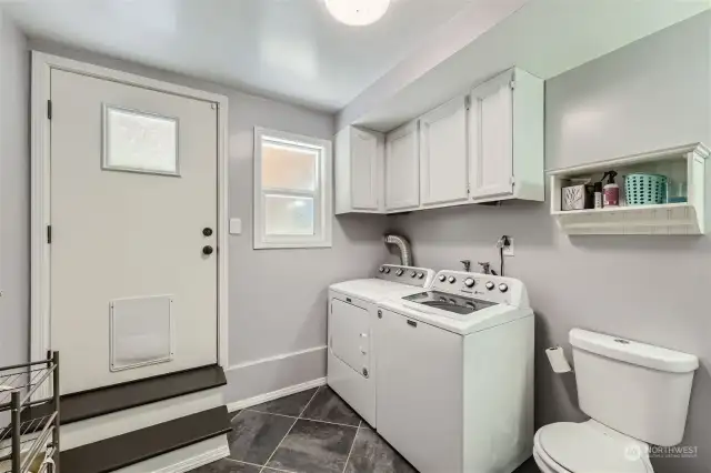 Roomy Laundry room with 1/2 bath and door to back yard