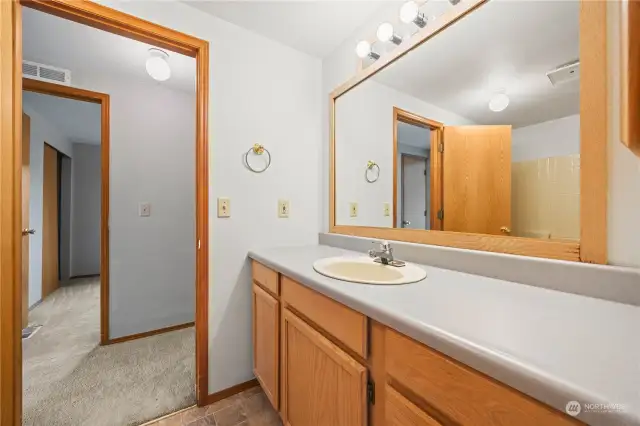 Guest bath is across the hallway from the guest bedroom and next to the laundry room for guests.