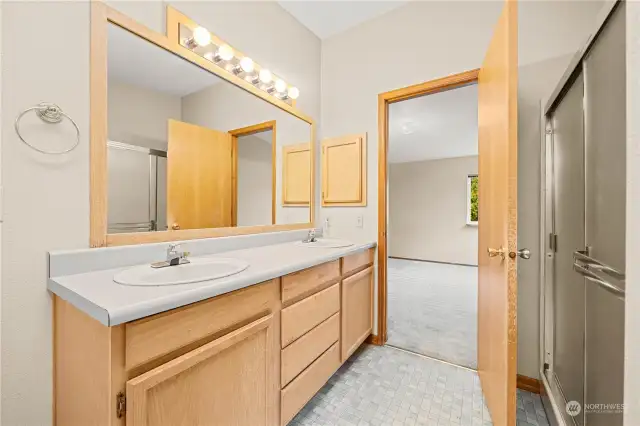 Main Bathroom with walk in shower and double sinks.