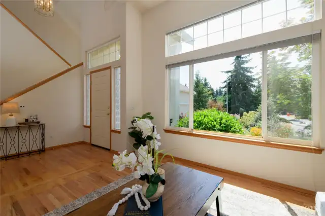 Rich red oak hardwood floors greet you with timeless elegance and warmth. Tall ceilings and an abundance of windows bring in lots of natural light and showcase the stunning beauty of the gorgeously curated landscaping surrounding the home.