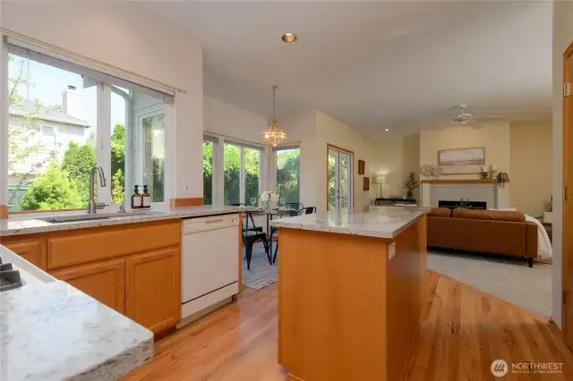 The kitchen enjoys expansive Quartz counters, a large pantry, gas range and radiant natural light—crafted for both culinary creativity and casual connection.