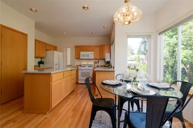 Bright, airy, and welcoming, this kitchen is where comfort meets the serene beauty of the gorgeous back yard views.