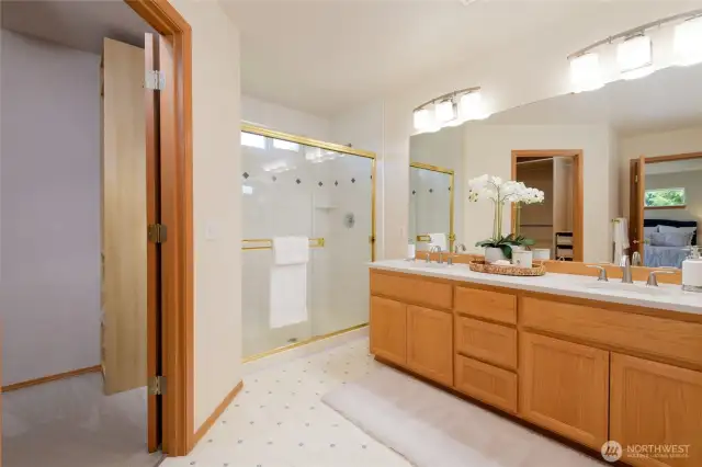 Enjoy the luxury of a walk-in closet and a second closet for added storage. The en suite bathroom is designed for relaxation, featuring dual vanities, and a walk-in shower. Additional perks include serene views of the landscaped yard, quiet separation from other bedrooms, and an overall sense of privacy—making it the perfect place to unwind at the end of the day.
