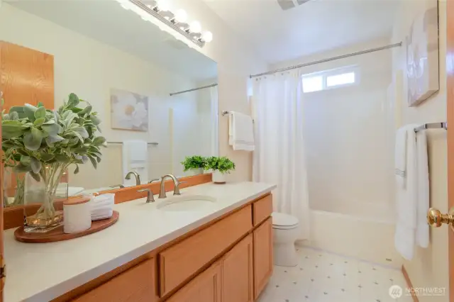 Second story Full bath with quartz countertops.