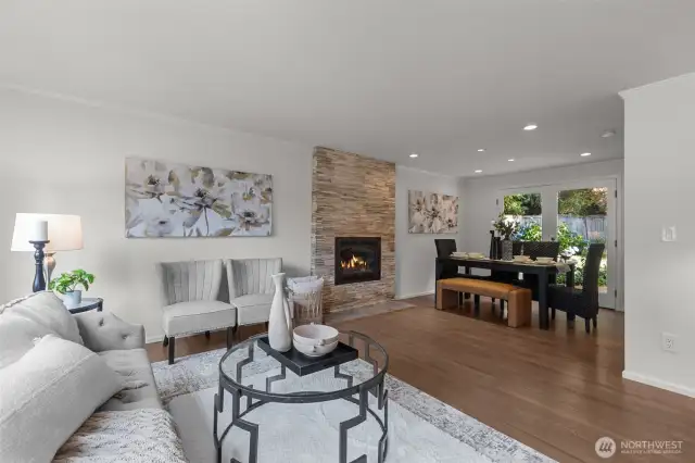 Living room to dining, a gas fireplace warms both rooms.