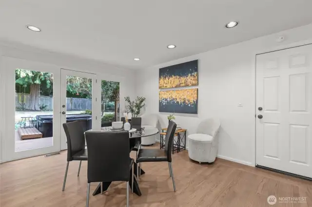 Generous North windows show off the backyard from the casual eating space.