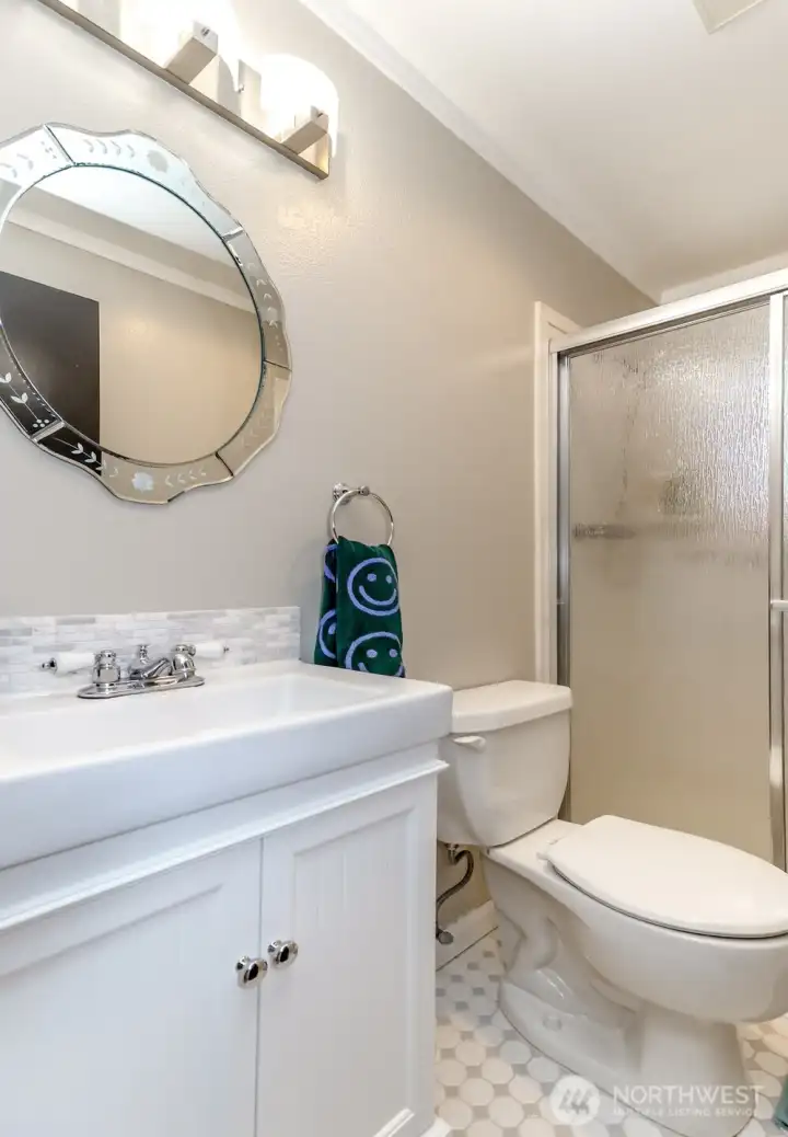 Updated bathroom features newer vanity and ceramic tiles
