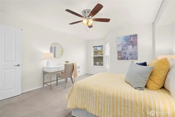 Bedroom has a ceiling fan.
