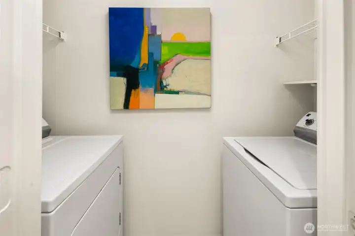 Washer and dryer off the full bathroom with nice storage above the two units.