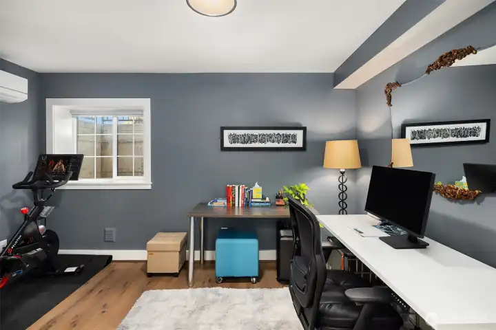 The lower level includes an additional bedroom suite, ideal for guests or as a versatile flex space.