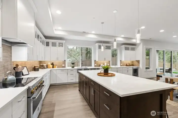 Huge, open kitchen with gorgeous soft close cabinets, quartz counters, induction range/oven, and full height tile backsplash.