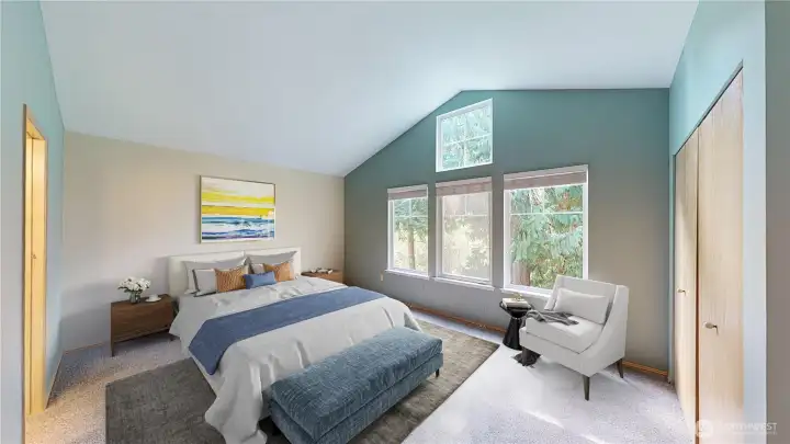 Virtually Staged Primary Suite has a vaulted ceiling, natural light, an ensuite bathroom and two closets. Large wall of windows overlooks common space - feels very private with big beautiful trees in the back & the ability to soak in the sunshine and nature from this second level condo.