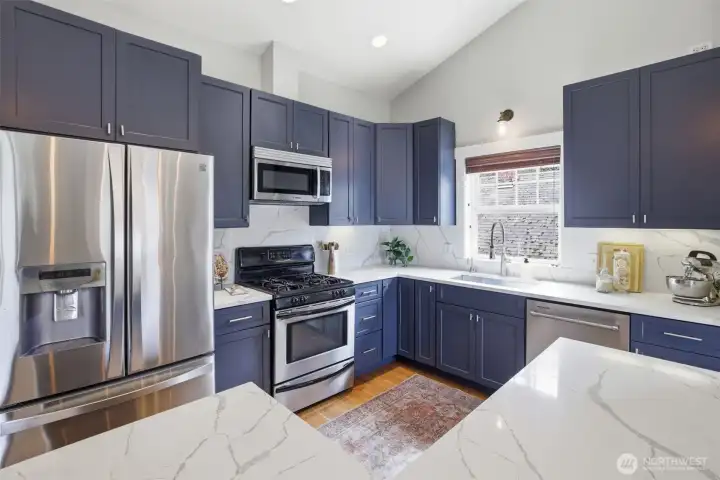 Granite countertops and stainless steel appliances.