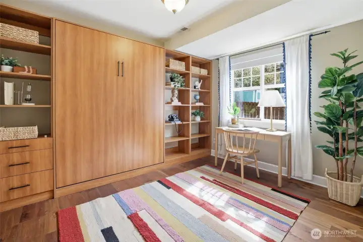 Flex room in lower level with custom built Murphy bed and shelving.