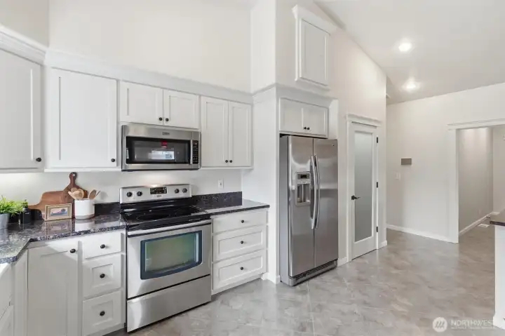Glass door to pantry beside fridge
