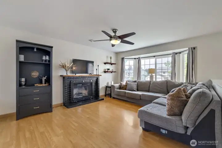 Spacious living room with a cozy wood-burning fireplace.