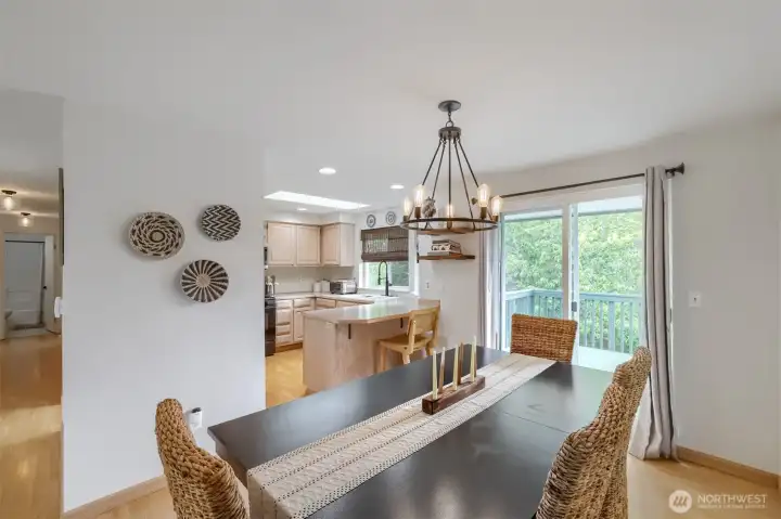 Dining room features designer lighting for an elevated touch. Enjoy easy indoor-outdoor living with slider access to the deck.