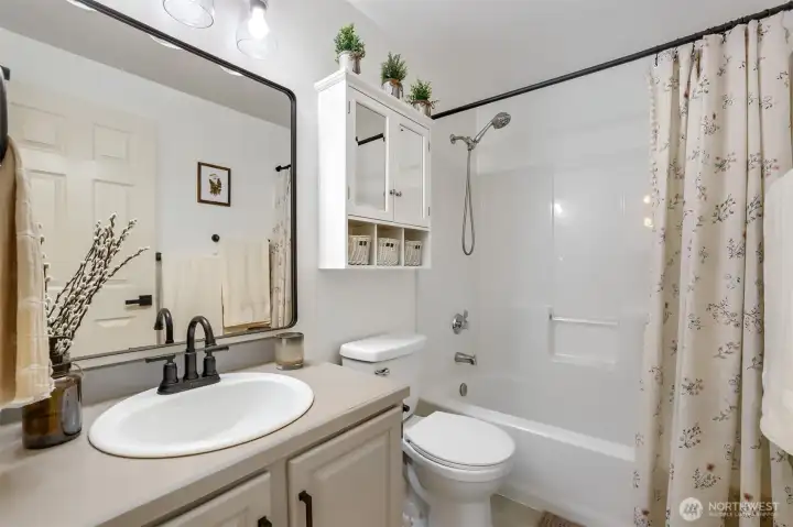 Full bath with tub/shower combo. Well-maintained finishes offer move-in-ready appeal.