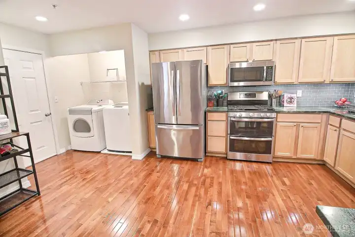 Full sized Washer & Dryer stay and conviently located within the confines of the large kitchen
