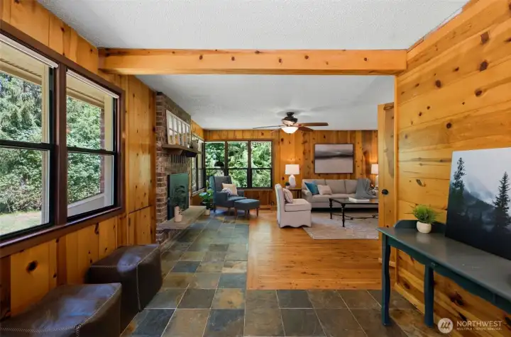 An open and inviting layout greets you at the door, showcasing beautiful slate and wood floors and warm accents.
