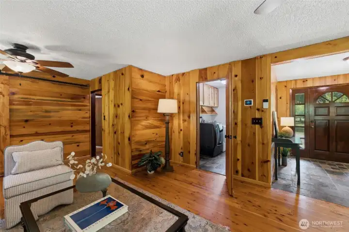A view looking back toward the front entry, highlighting the home's functional layout and convenient main-level laundry access.