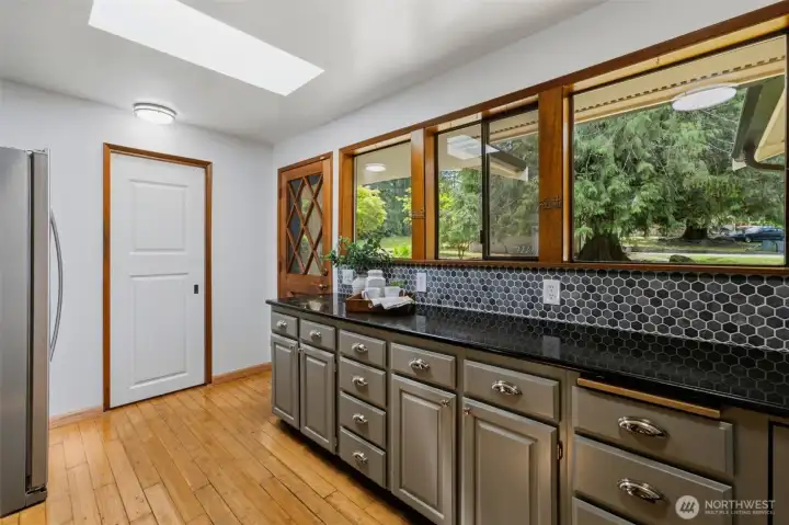 Enjoy the gorgeous view of your property through the many kitchen windows, while preparing the meals. The skylight adds fantastic natural light as well.