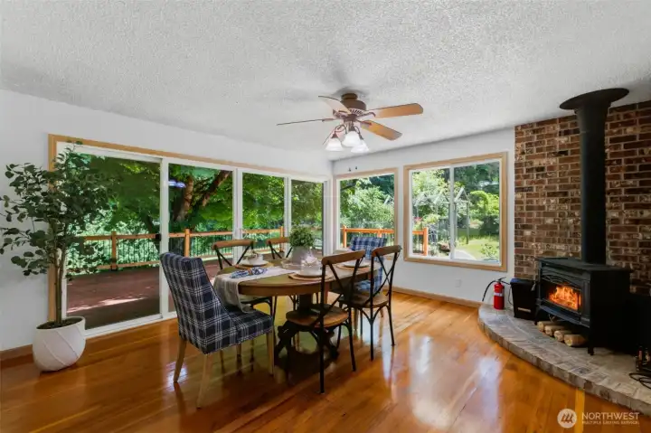 Isn't this the perfect place to share a meal, with a cozy wood stove and all of the windows to view your peaceful property? You could also saunter out through the sliding glass doors to enjoy a beverage on the expansive deck.