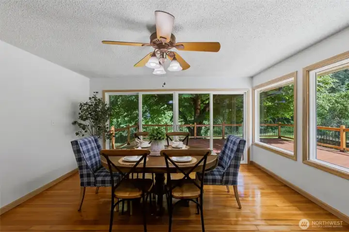 The stunning dining room features a wall of windows that frame picturesque views of your 6.5-acre property.
