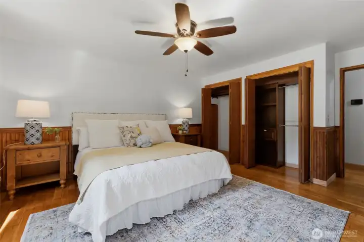 The spacious primary suite serves as a peaceful retreat, complete with warm wood accents and plenty of natural light.