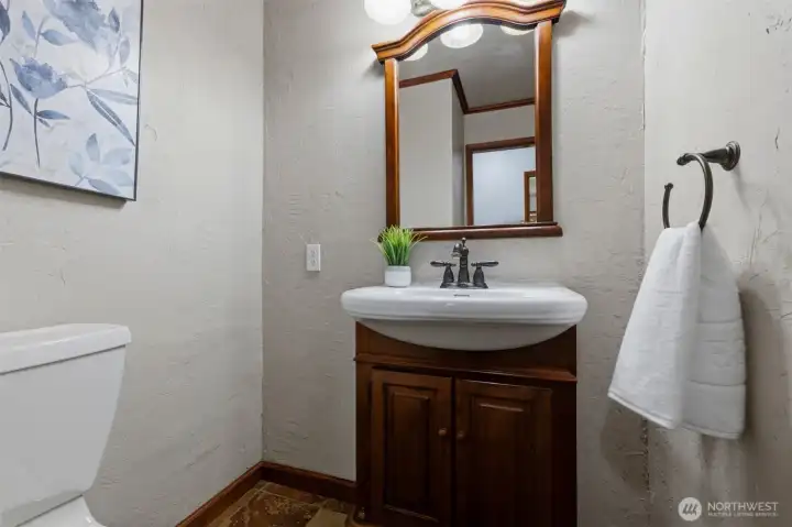 Clean, updated, and functional—the home's powder room is perfectly situated for guests and daily use.