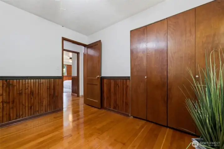 Beautiful rich wood tones and ample closet space in this bedroom.