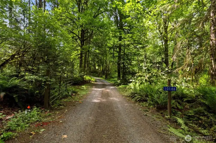 Ultimate peace and privacy start at the gated entry, guiding you down a scenic drive completely removed from the road.