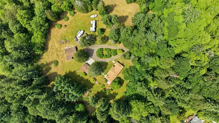 A bird's-eye view captures the true beauty and impressive scale of this 6.5 acre retreat. It highlights the perfect blend of cleared fields, mature trees, a wonderful home and additional outbuildings, proving that you really can have it all.