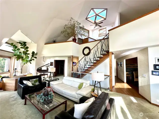Soaring 24' ceilings with stunning Skylight topper - and beautiful custom hand-carved metal sea grass staircase railing created by local Camano Island artist.