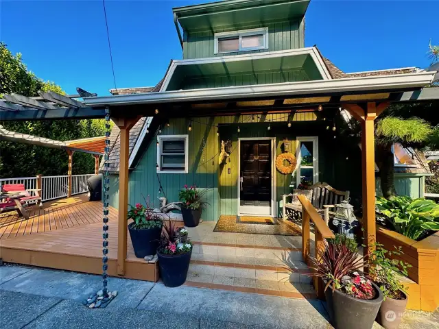 Welcome visitors to the lovely covered Front Porch and Wrap Around Deck.