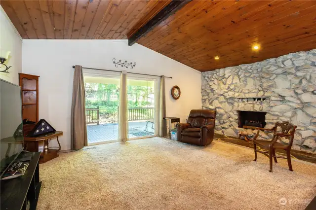 Stately vaulted ceiling, sliding glass door leads to rear deck.