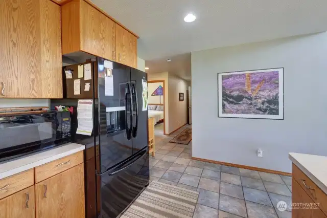 Just beyond the kitchen are the guest bedrooms, bathroom, laundry, and garage.