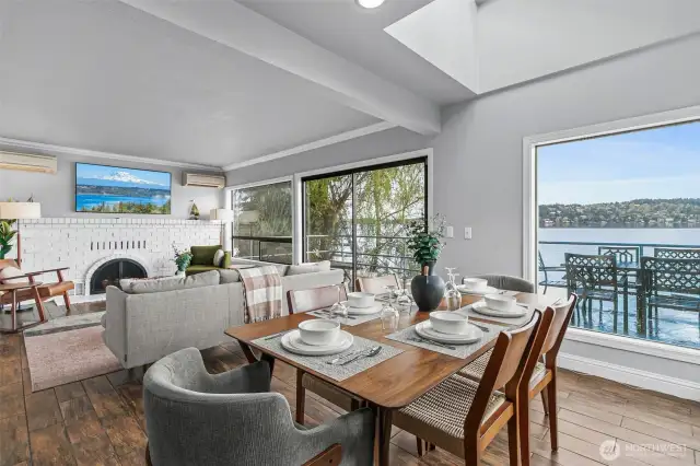 The dining room features many unique and dynamic features, from its exposed beam ceilings, to the beautiful brick surround fireplace, its warm wood floors, and its near floor to ceiling view windows. This room is truly stunning!