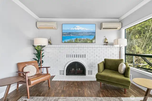 The living room features the beautiful brick surround fireplace, one of the home's most unique architectural details.