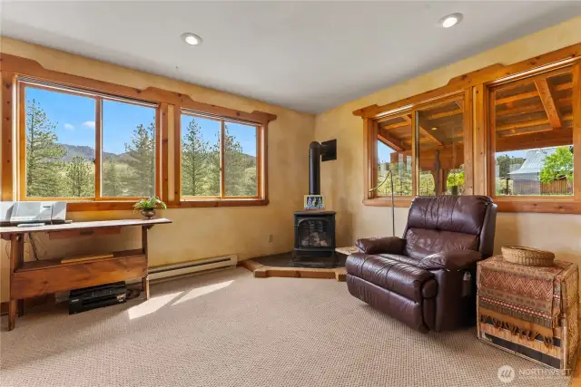 The studio-style apartment has big windows and is large enough for a separate seating area.