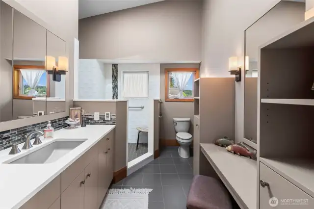 The primary bath is compact, functional, and in harmony with the home’s clean, modern lines with a walk-in closet and extra storage with style.